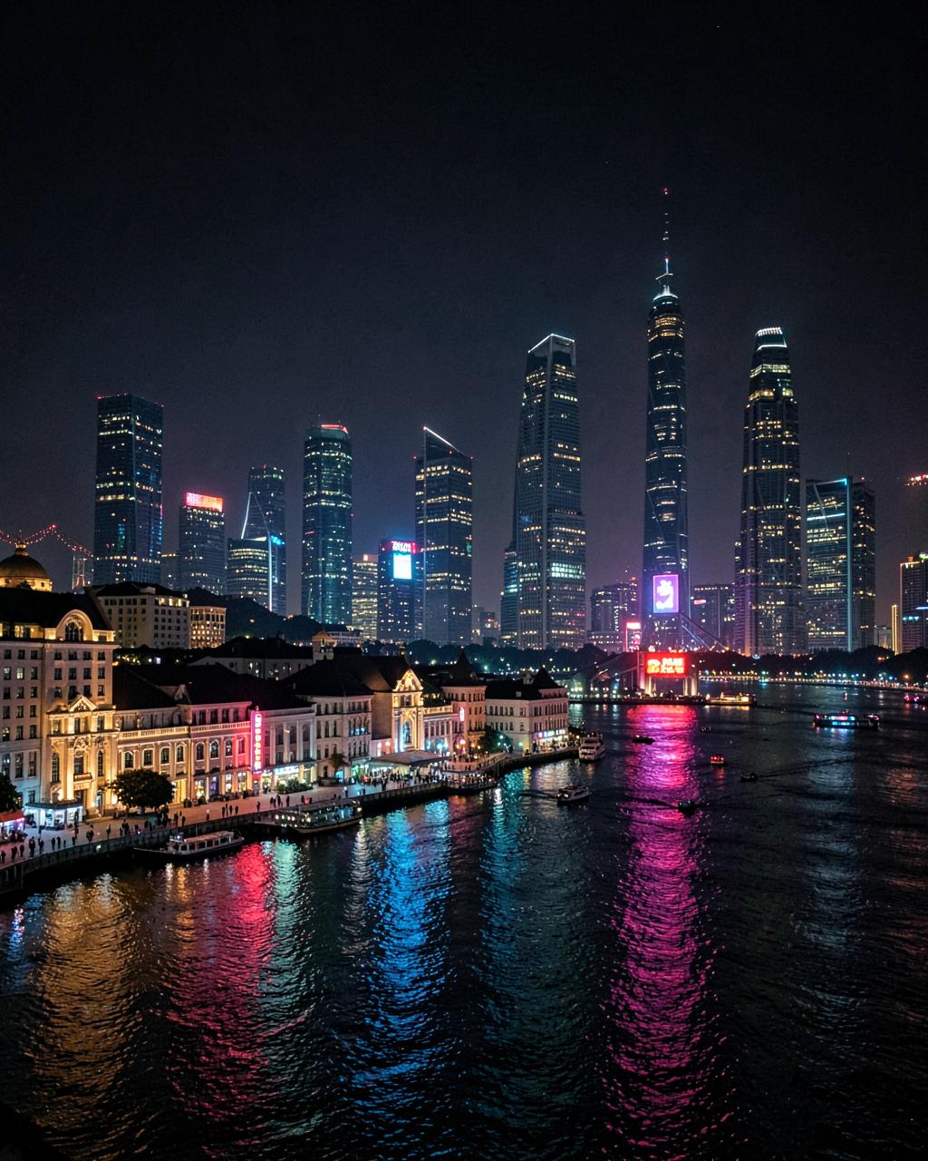 Shanghai skyline at night with the historic Bund and neon reflections on the Huangpu River